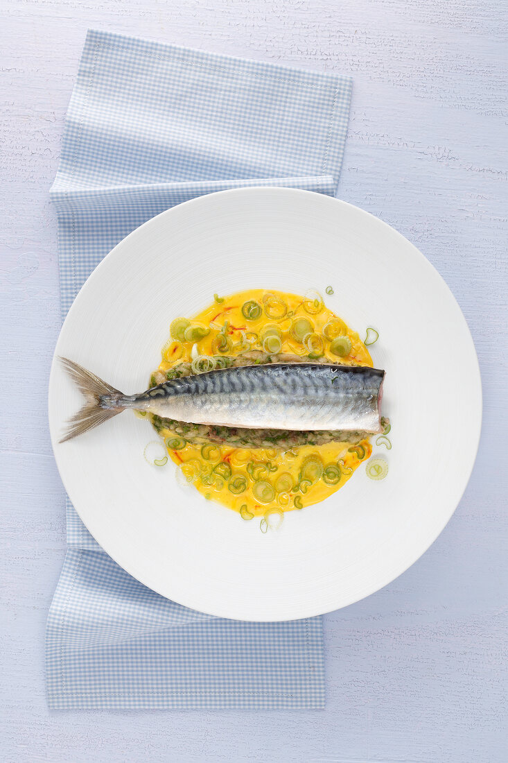 Mackerel with aubergine caviar and saffron yoghurt sauce on plate