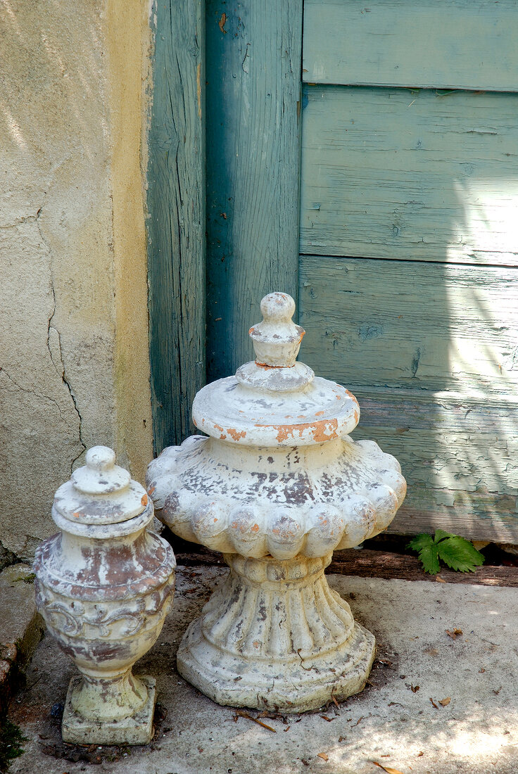 Old white patinated urns