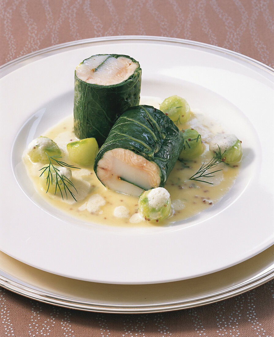 Close-up of salmon roulade with scallops in danube on plate