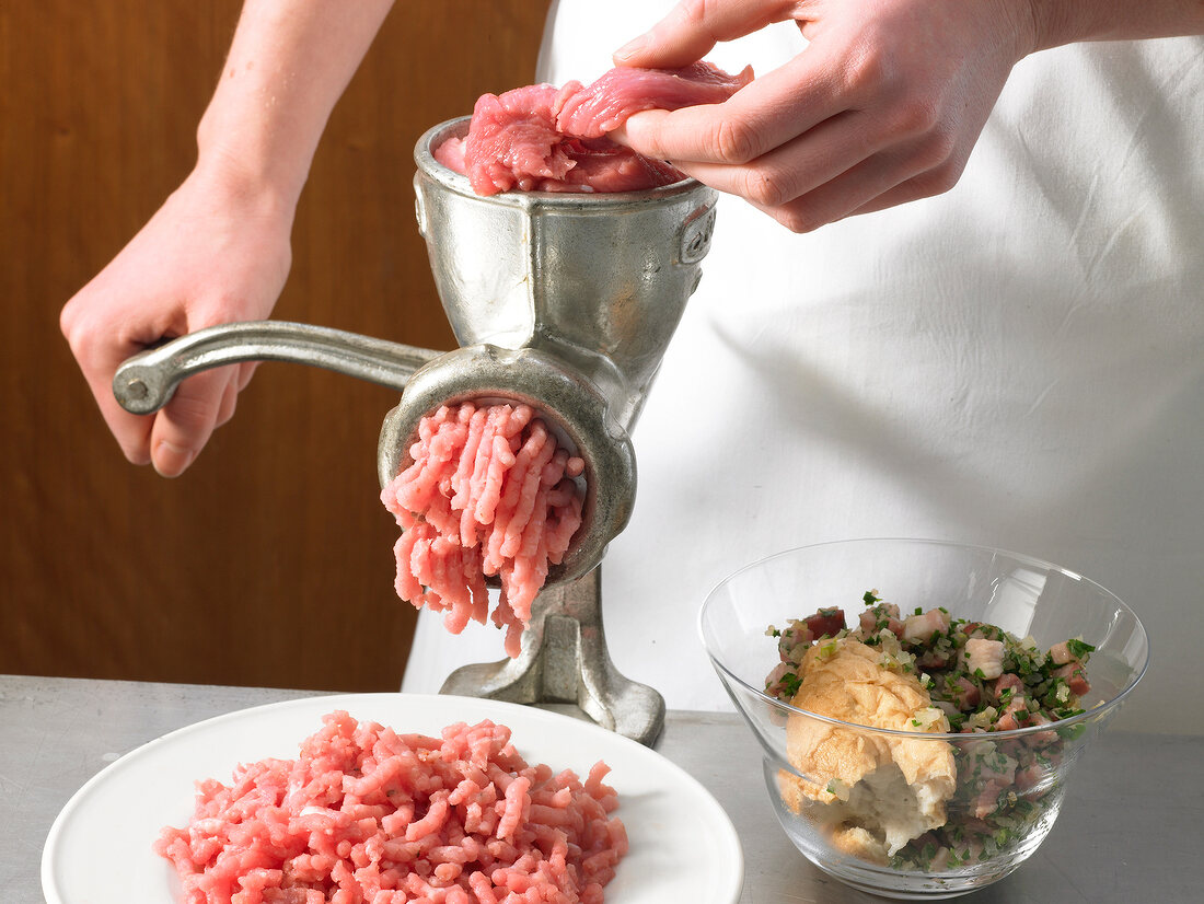 Passing meat through meat grinder, step 1