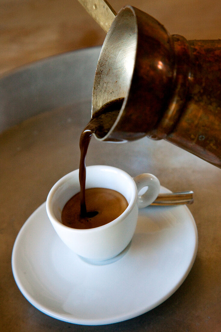 Close-up of cup being filled with coffee