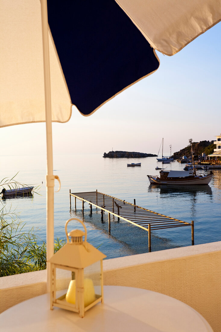Porto Loutro hotel terrace overlooking bay boats in Crete, Greece