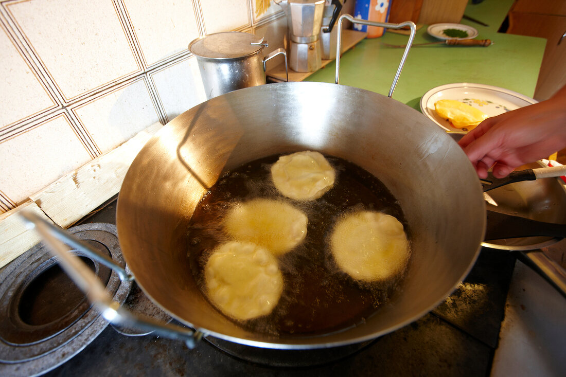 Dumplings being fried in pan