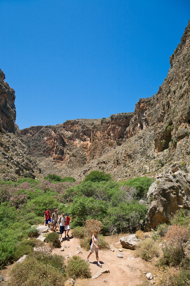 Tourists walking between valley in Zakros Gorge, Crete, Greece