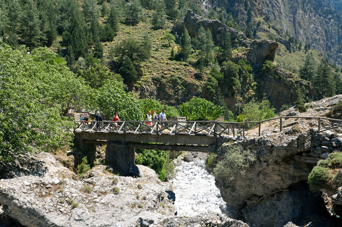 Tourists walking on bridge of Samaria Gorge in Crete, Greece