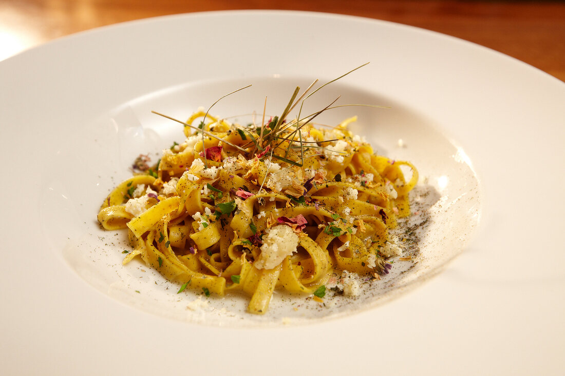 Close-up of Berghei nudeln pasta with gray cheese on plate