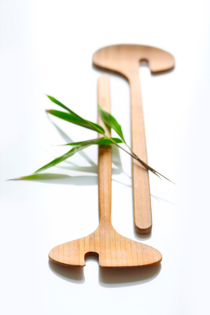 Two wooden salad spoons on white background