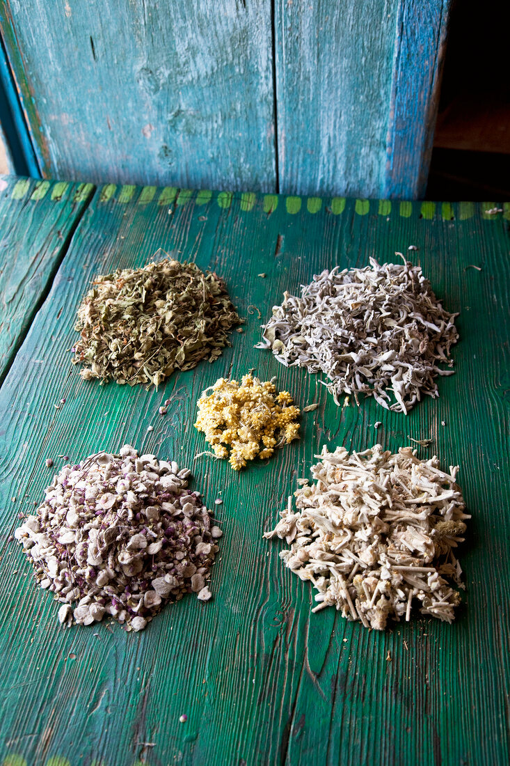 Piles of sage, rockrose, bergtee, and diktamus on green background