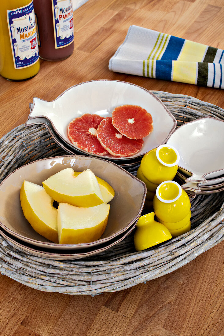Bowls with grapefruits and melon