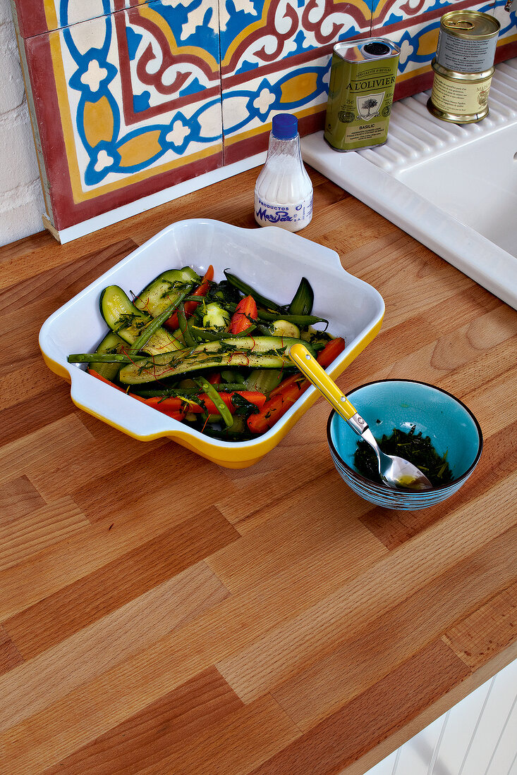 Steamed zucchini and peppers in serving dish