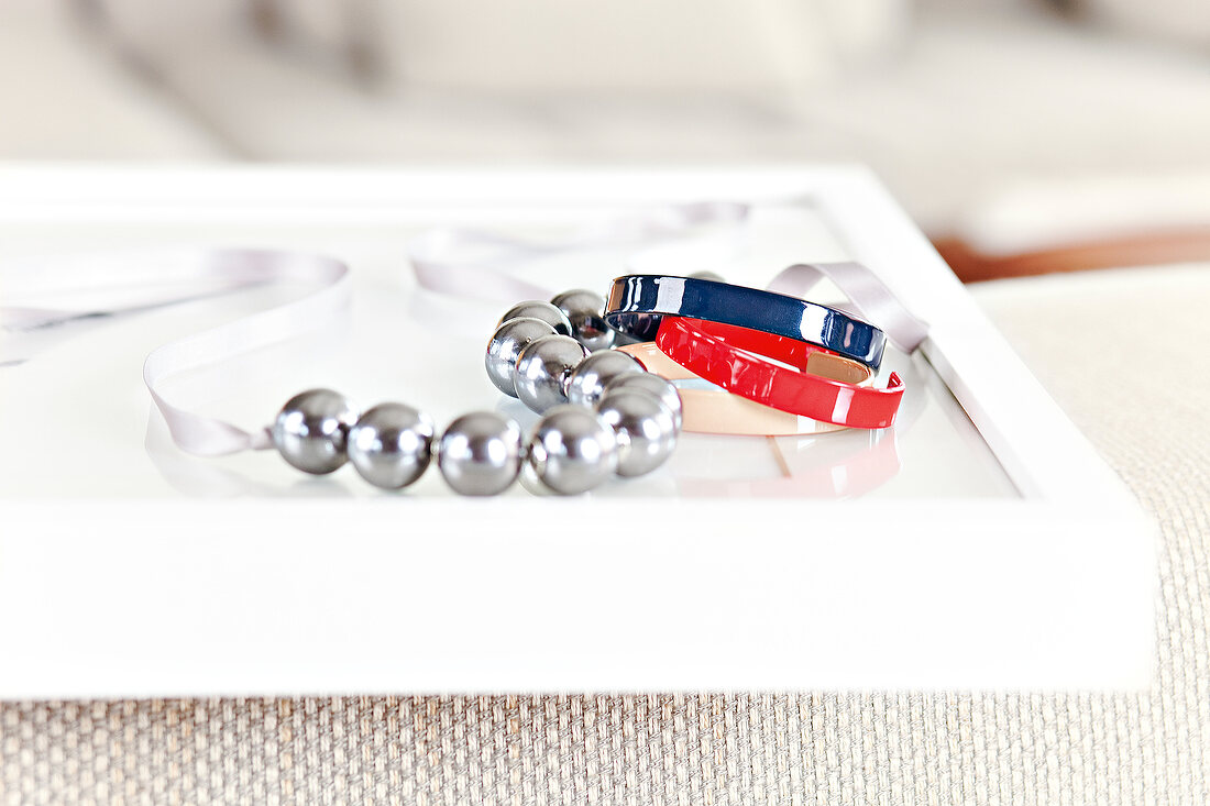 Red and blue bracelets with silver bead chain