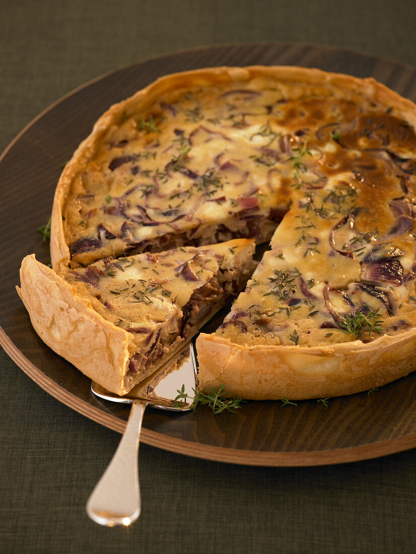 Quiche with red onion and fresh goat cheese on plate