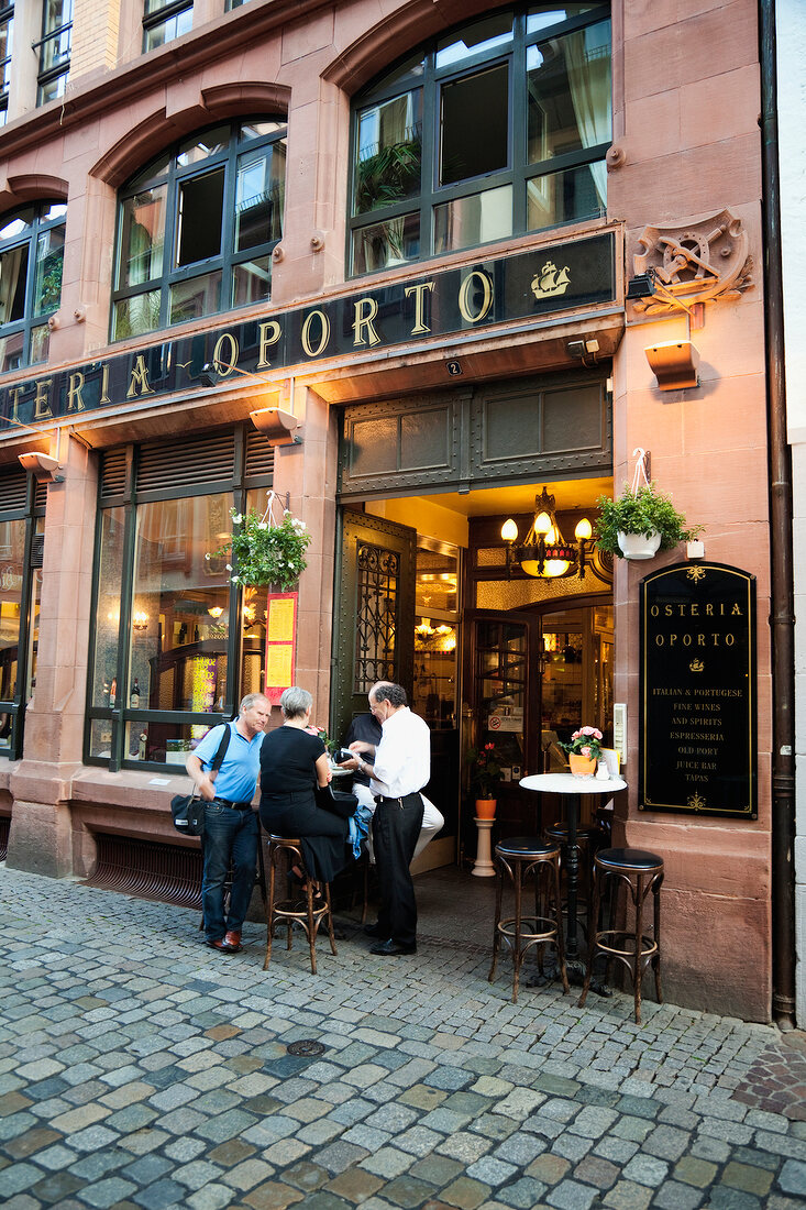 People standing outside restaurant Osteria Oporto in Freiburg, Black Forest, Germany