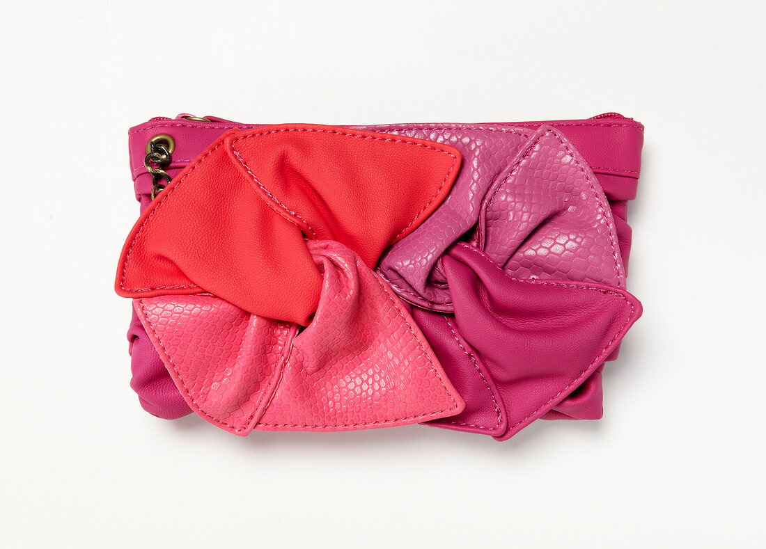 Close-up of pink clutch on white background
