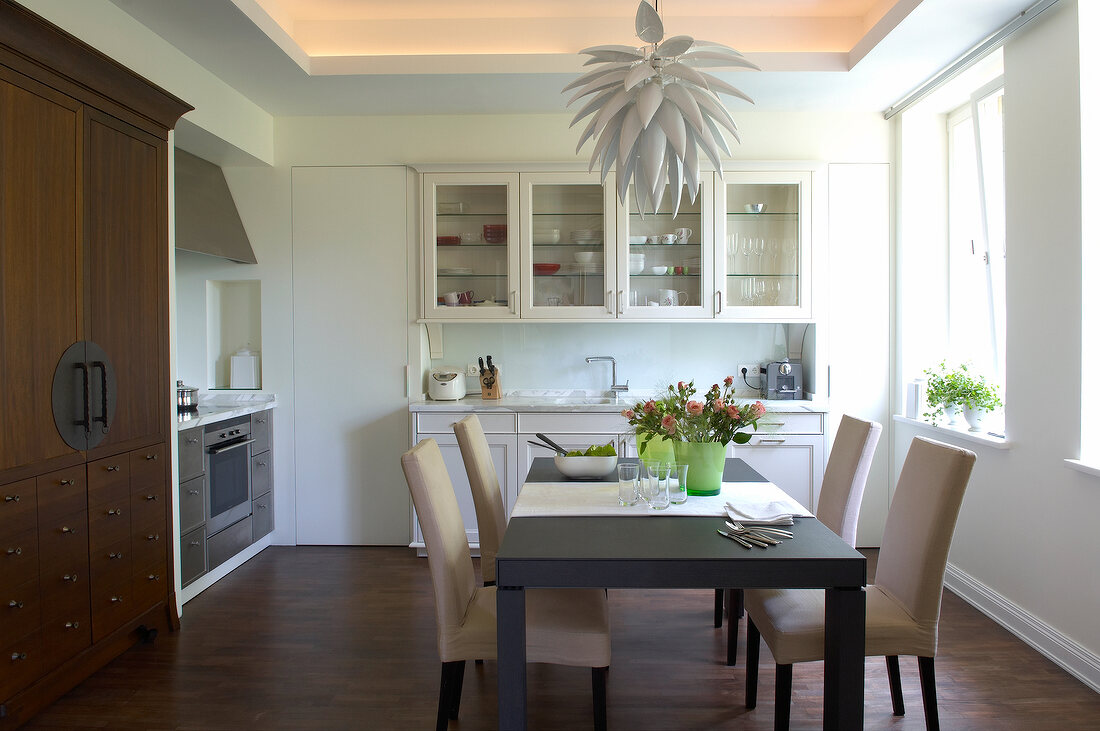 Modern kitchen with dining table, drawers and cabinets