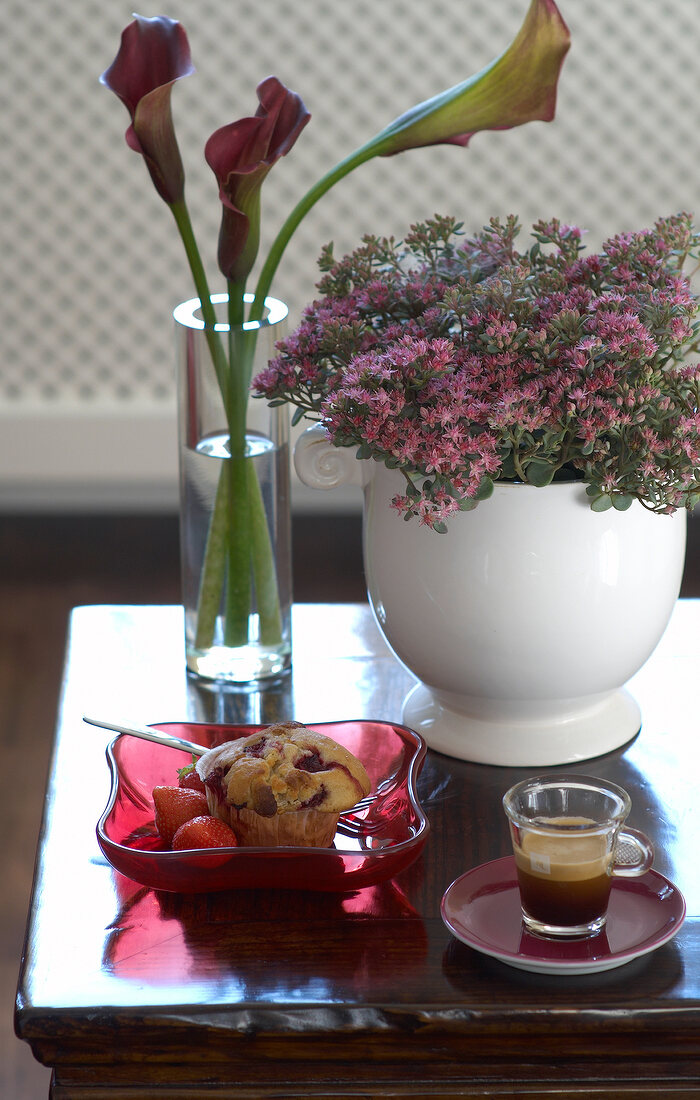 Muffin and cup of espresso on side table