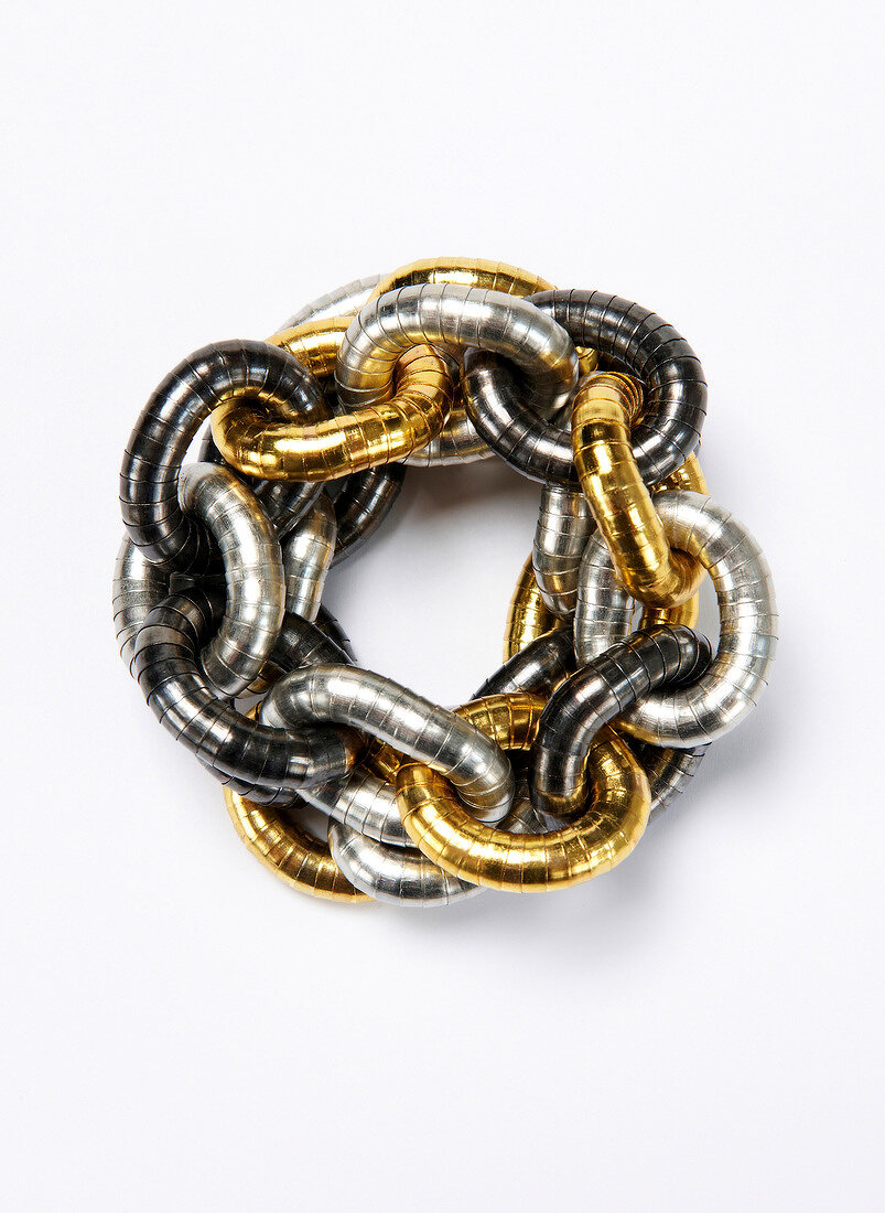 Close-up of gold and silver bracelets on white background