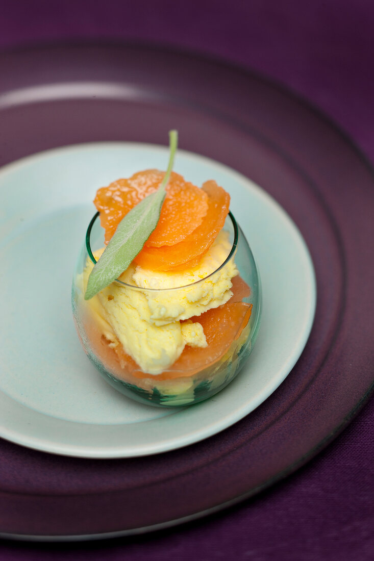 Close-up of glass of sage ice cream with melon on plate