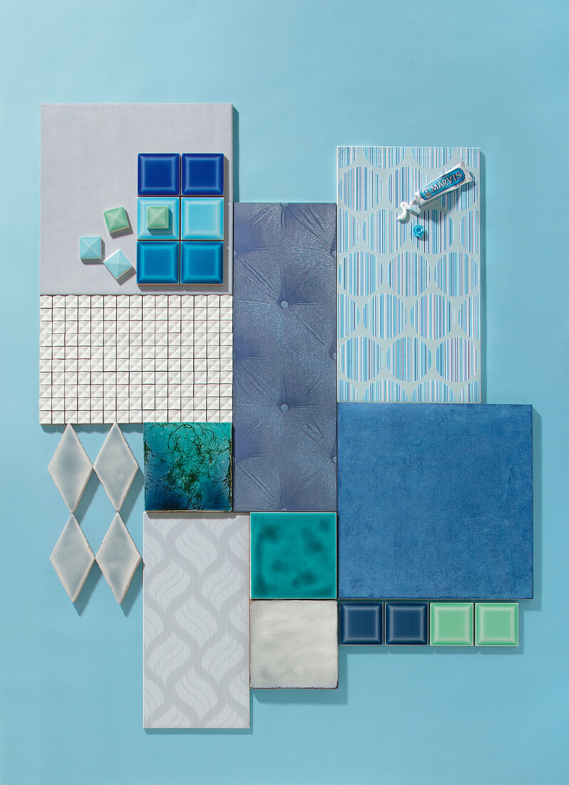 Various blue mosaic tiles scattered on blue background