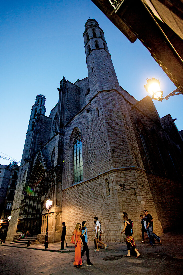 People outside Santa Maria del Mar Church at evening in Barcelona, Spain