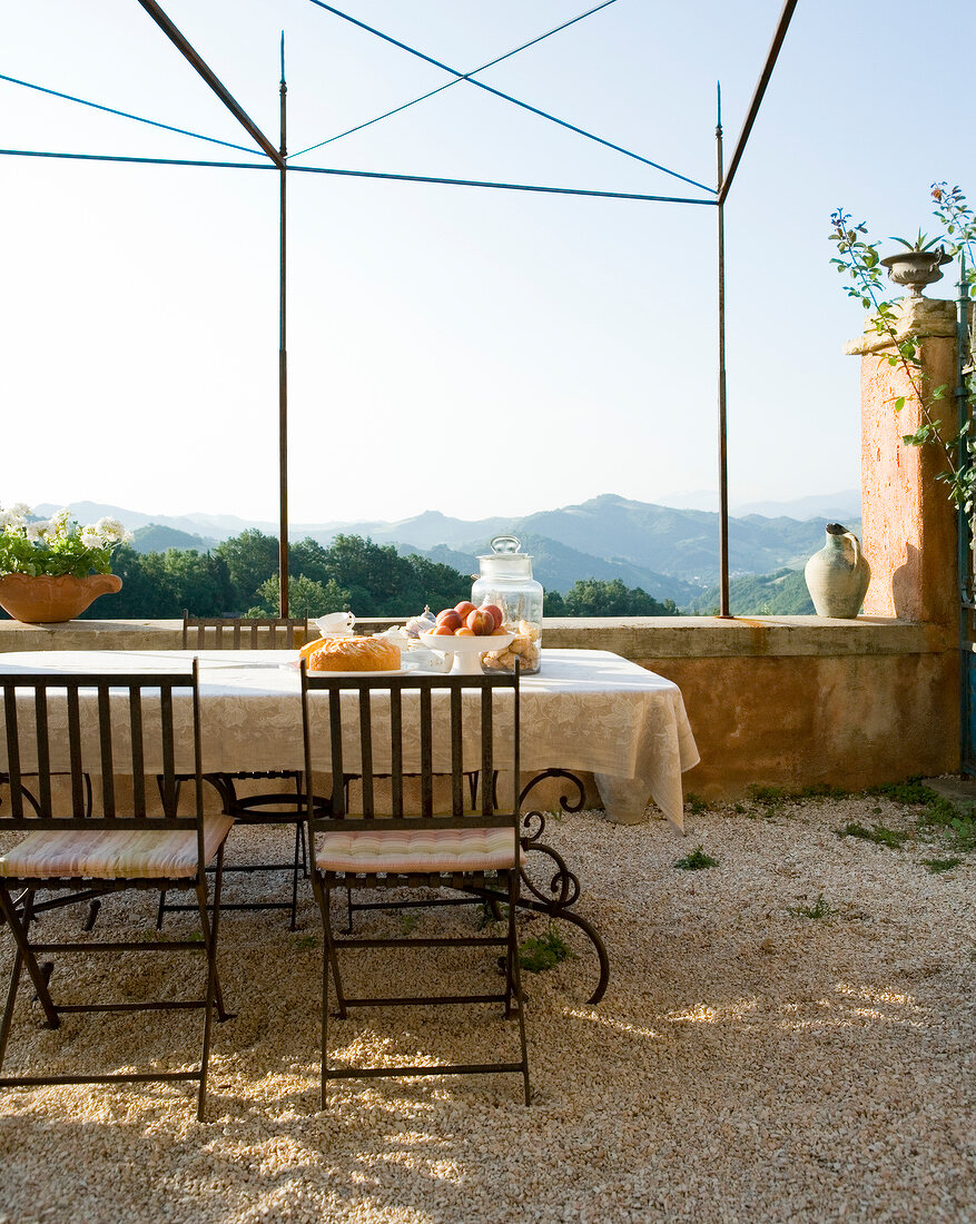 Patio table with chairs overlooking the Marche region, Palazzo, Tuscany, Italy