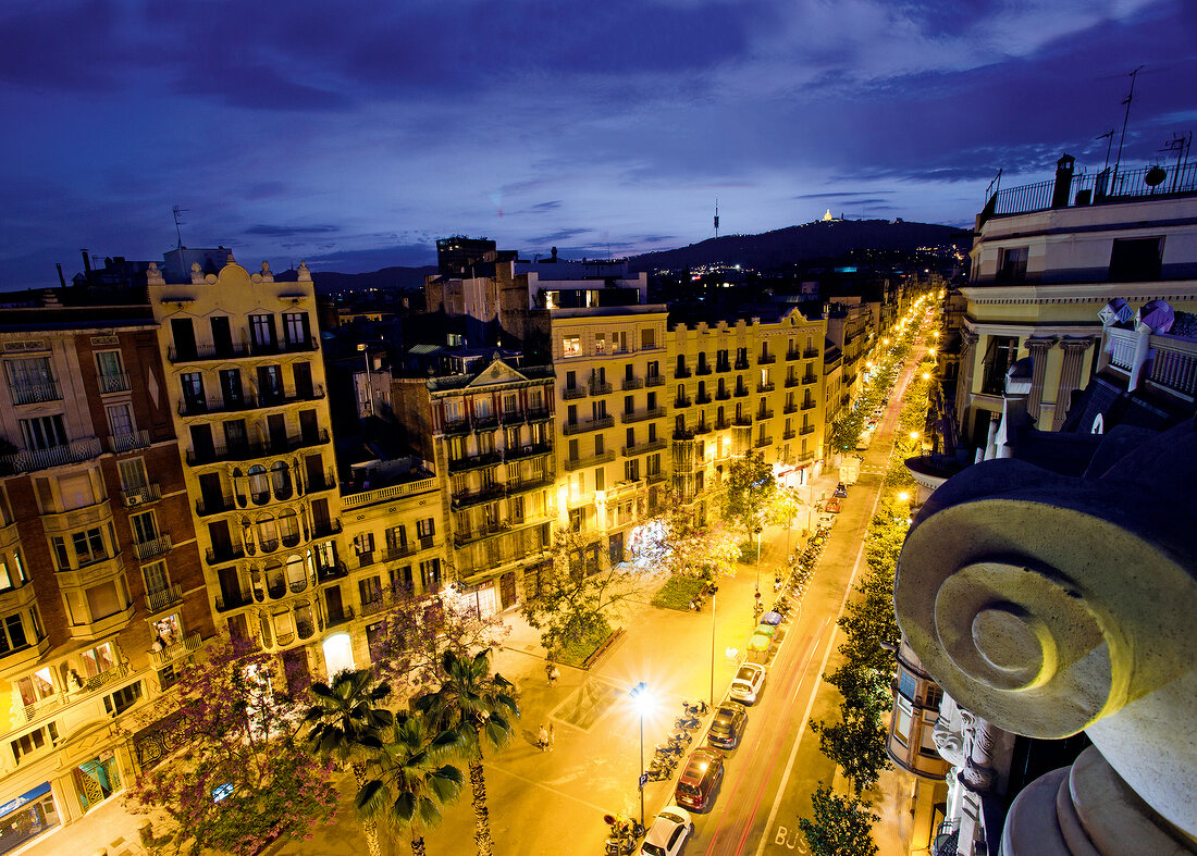View of buildings and street lights at evening in Gracia, Barcelona, Spain