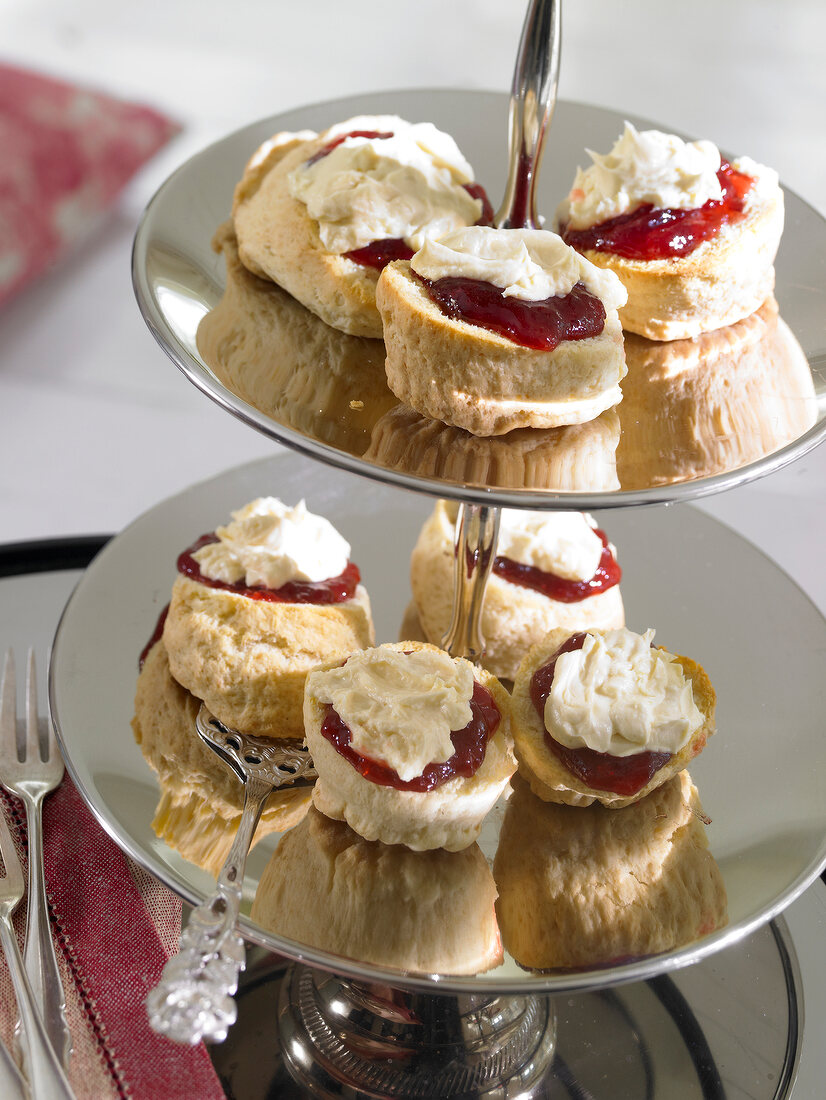 Close-up of scones with strawberry jam and clotted cream on cake stand