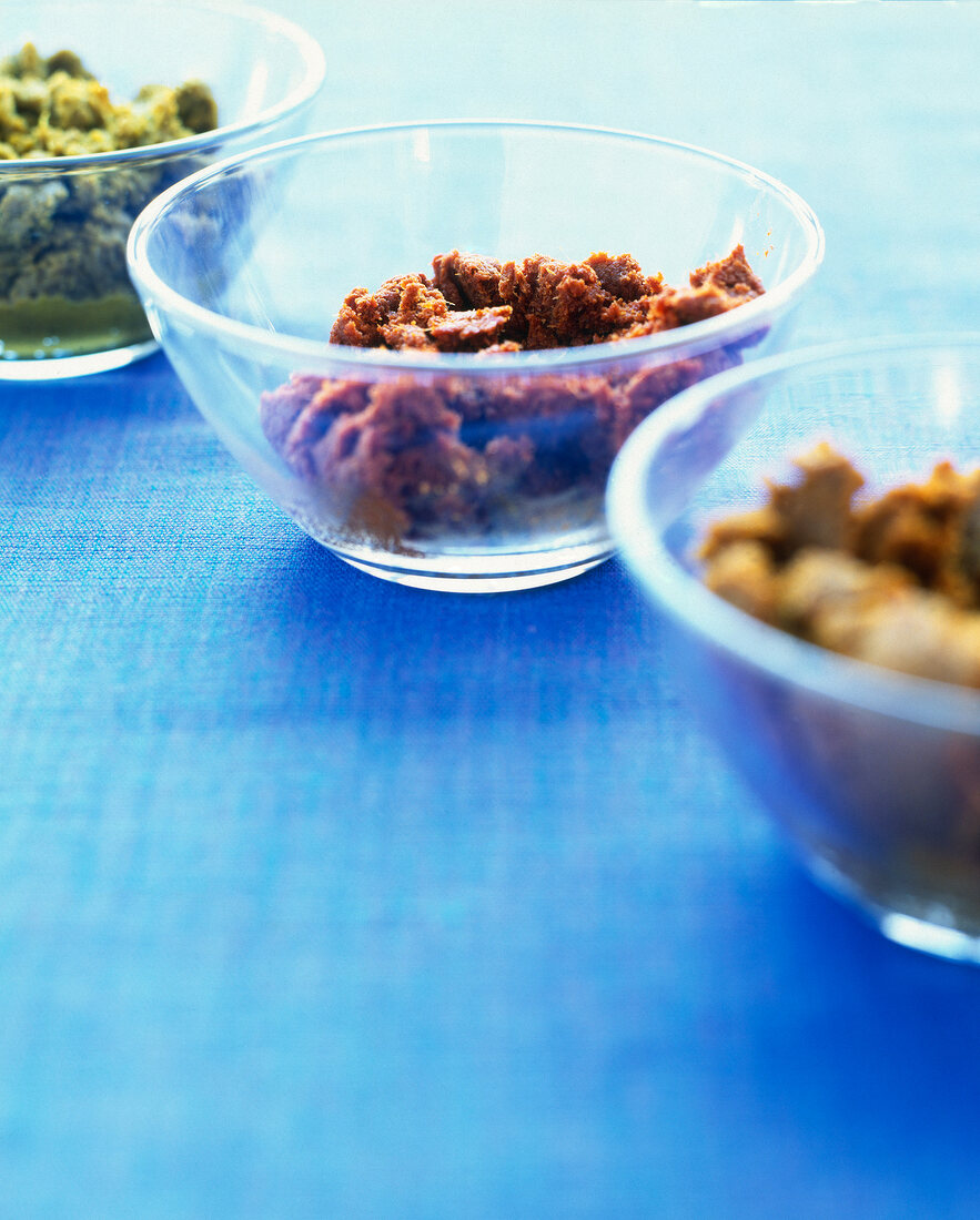 Close-up of glass bowls of curry pastes