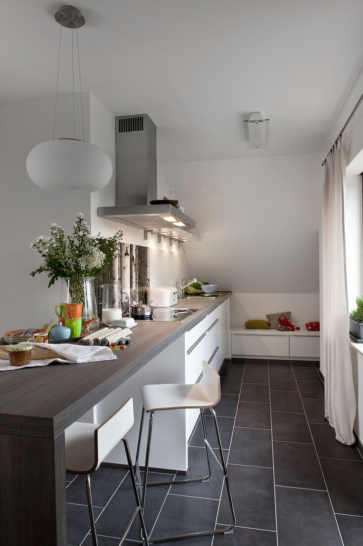 Table, chair, cabinet and shelf in modern kitchen