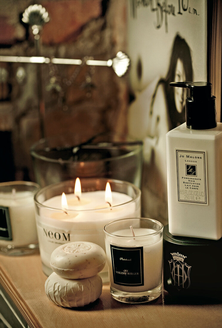 Close-up of scented candles, soap and body lotion