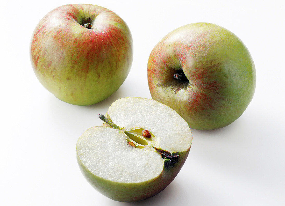 Two whole and one half gravenstein apple