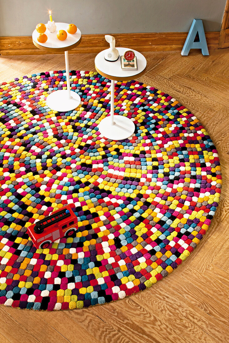 Side tables and fire truck on colourful pop art style carpet