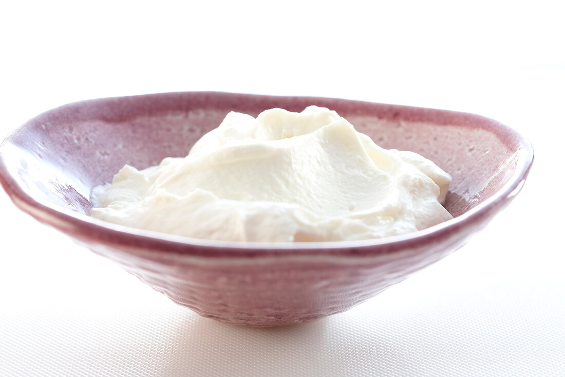 Magerquark in bowl on white background