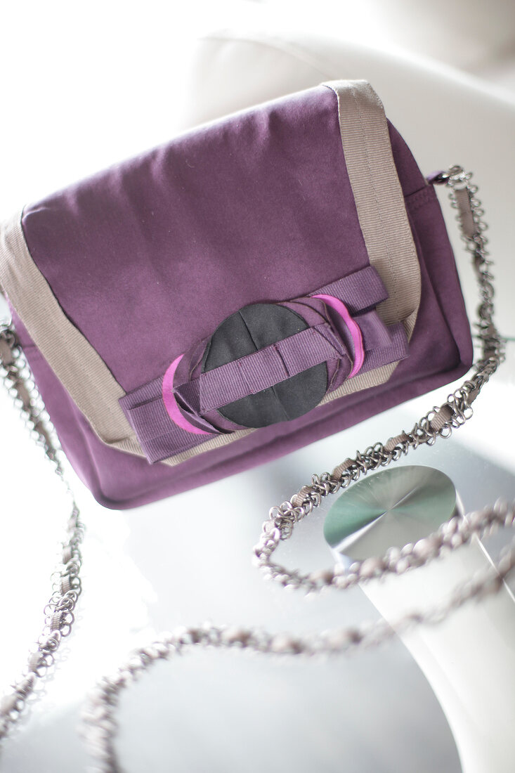 Close-up of purple-grey satin shoulder bag