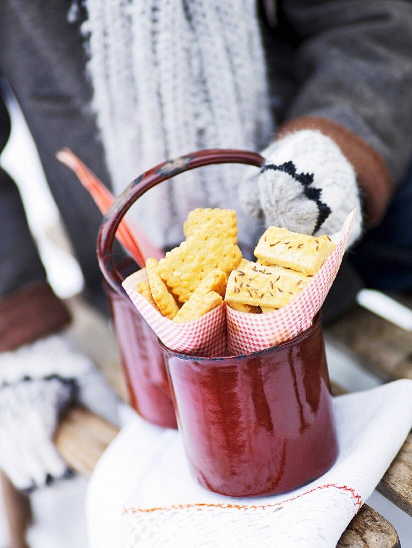 Cheese biscuits and savoury biscuits in a red pot