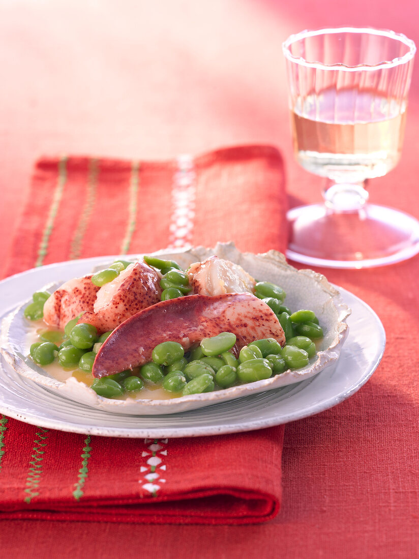Broad beans with lobster in serving dish