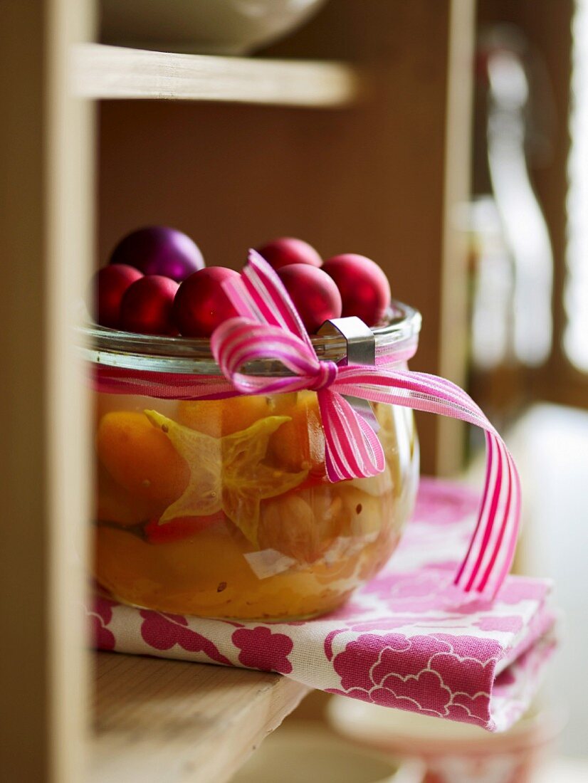 Exotic mustard fruits in a jar decorated for Christmas