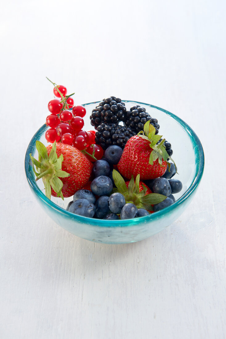 Various fresh berries in glass bowl