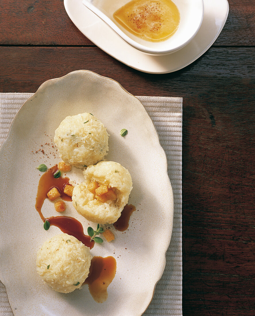 Close-up of potato dumplings filled with croutons in serving dish