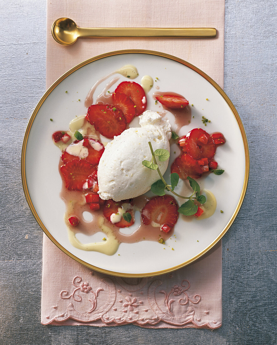 Curd mousse with strawberries and mint on plate