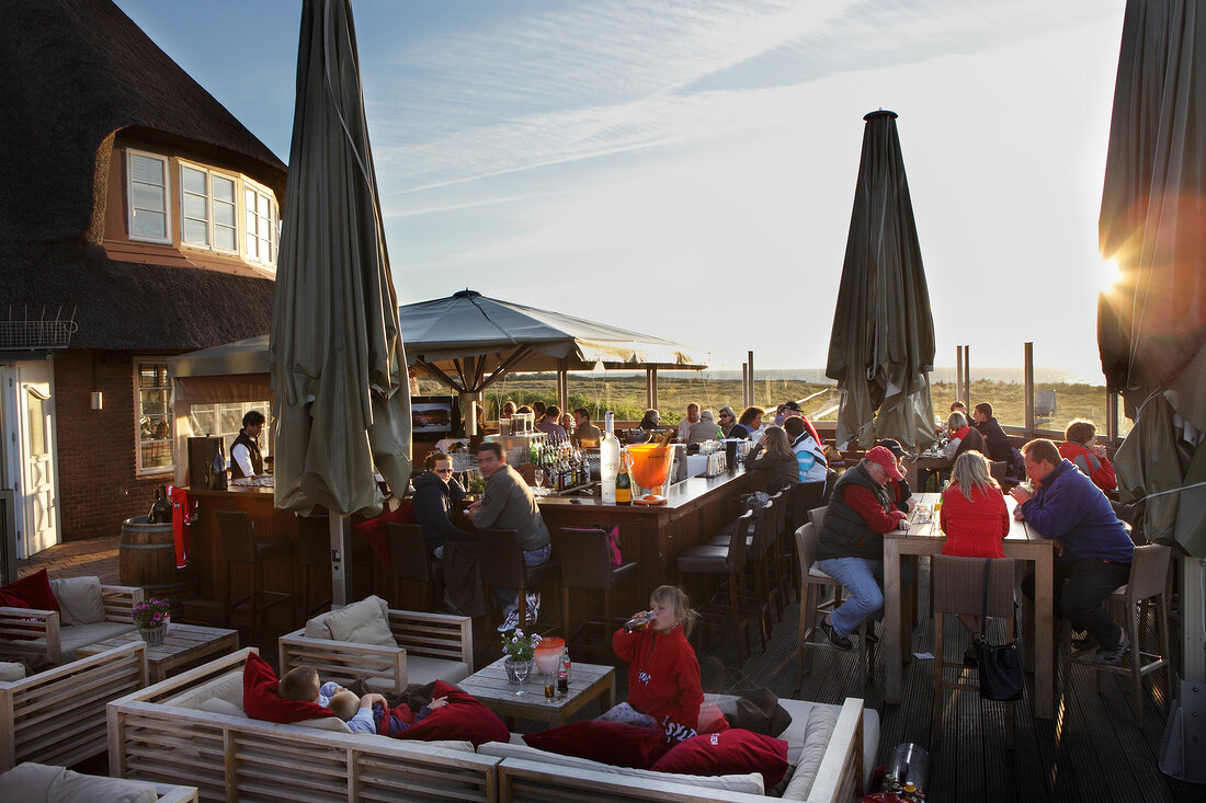 People sitting at bar and restaurant in dusk, Sylt Island, Schleswig-Holstein, Germany