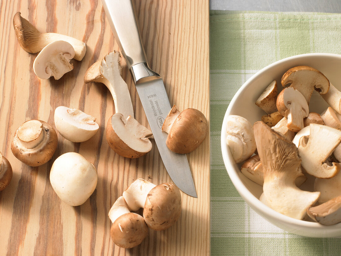 Whole and halved mushrooms on cutting board, step 3