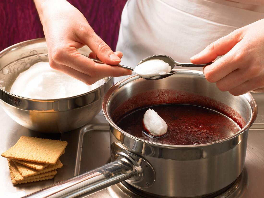 Add dollops of fluffy egg whites to mixture in saucepan, step 2