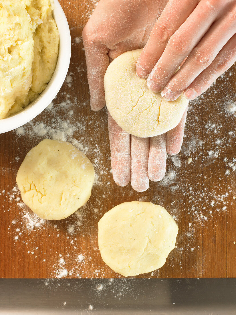 Moulding dough with hands for preparation of plum dumpling, step 1