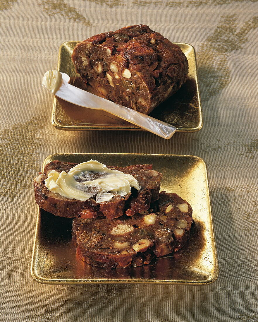 Close-up of fruit bread with butter in serving dish