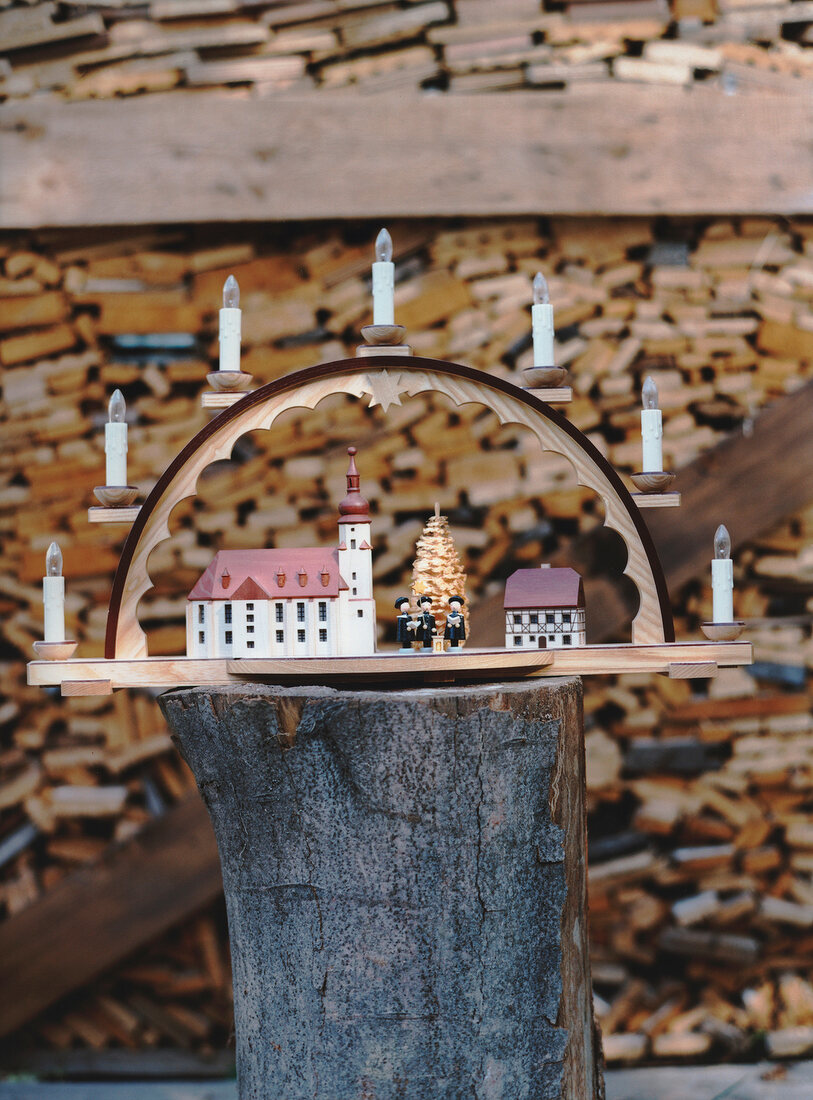 Close-up of Christmas toys with arch, church and carol singers