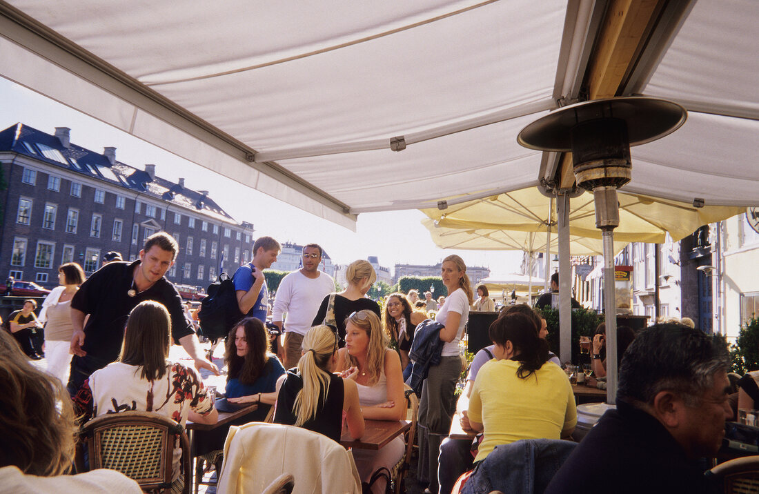 People in Sidewalk Cafe at Nyhavn, Copenhagen, Denmark