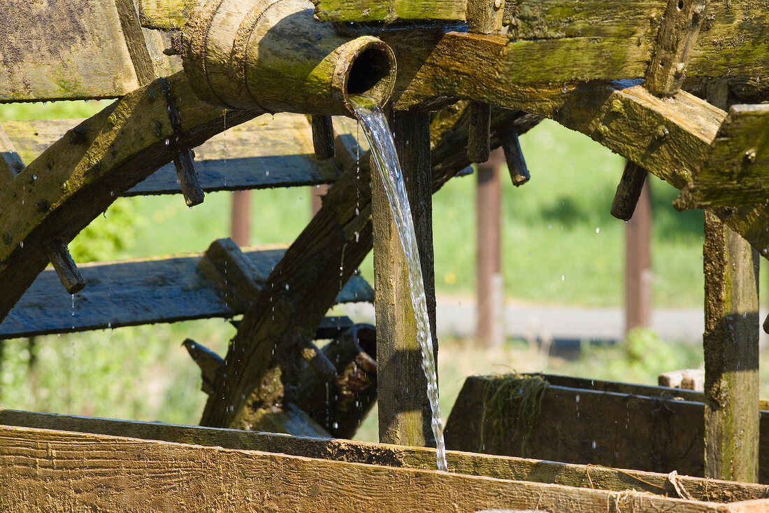 Water falling through wooden tube in Nature Park, Franconian Switzerland, Bavaria, Germany