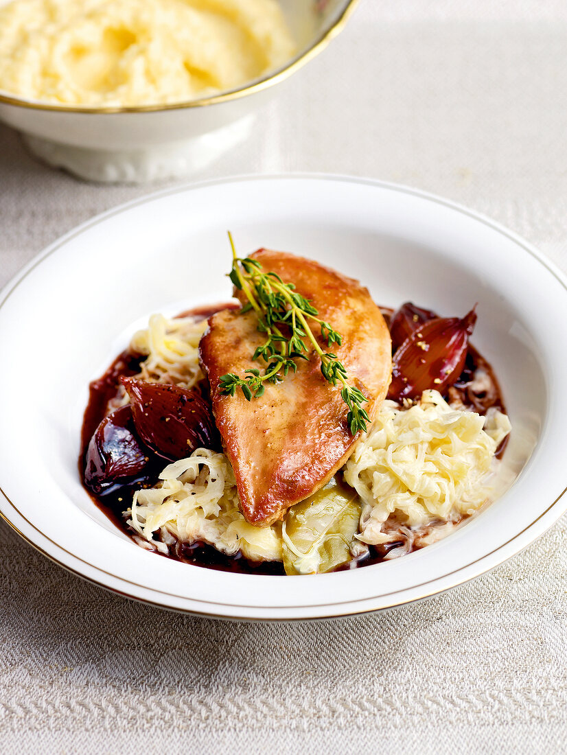 Pheasant breast with port wine, shallots and cream cabbage in bowl
