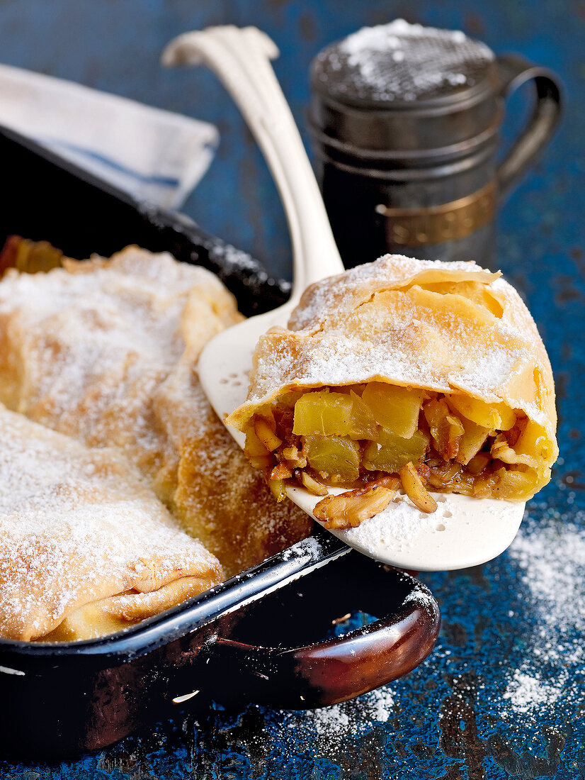 Classic apple strudel with walnuts and almonds in baking tray